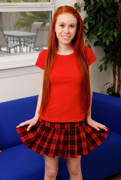 Симпатичная рыжеволосая Долли Спайс снимает свою клетчатую юбку и трусики, чтобы позировать обнаженной картинка 1