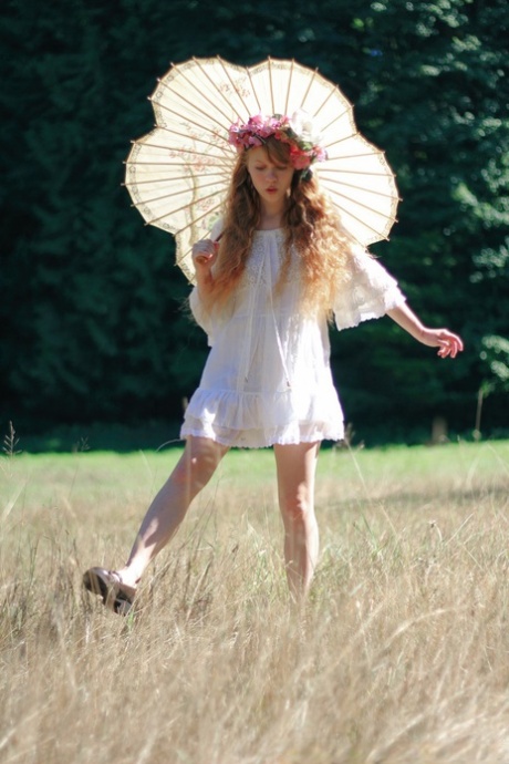 Очаровательная рыжеволосая молоденькая Долли Литтл держит зонтик, пока раздевается картинка 4