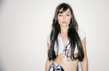 Сольная модель Саша Грей снимает свой топ, оставаясь в плиссированной юбке и чулках картинка 1